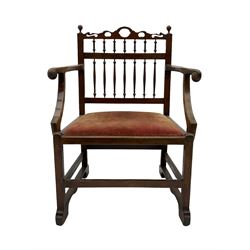 Late 18th century walnut 'Drunkard's' chair, the shaped and pierced cresting rail over spindle back, wide drop in upholstered seat, the arm terminals carved with roundels, on sledge supports with bracket feet, joined by stretchers