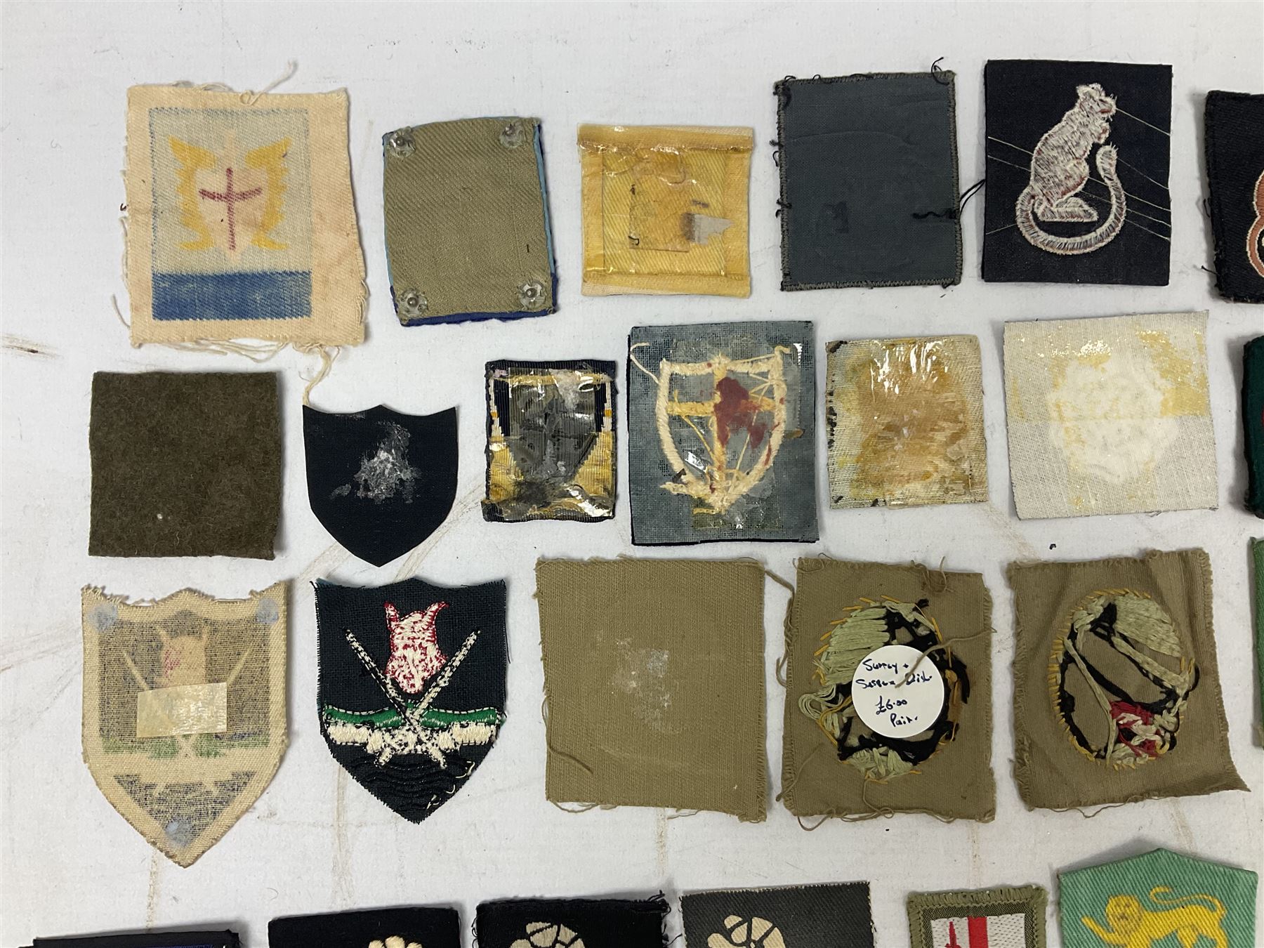 Approximately one-hundred printed and embroidered cloth badges including Royal Tank Regiment, Royal Armoured Corps, 219th Independent Infantry Brigade, Cyrenaica, Cyprus, Singapore and other districts, Gibraltar Garrison, East Anglian Brigade, 20th Armoured Brigade and various armoured divisions etc