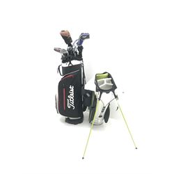 A quantity of TaylorMade golf clubs and others and two bags 
