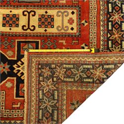 North West Persian Ardebil rug, three-medallion design with central octagonal starburst medallion flanked by two cruciform cartouche-style medallions, main field in terracotta red populated with hooked geometric, zoomorphic shapes and rosettes, main border with a series of eight pointed stars in alternating tones on a dark navy ground, separated by small diamonds and geometric fillers, inner and outer guard stripes with a classic reciprocal sawtooth motif 