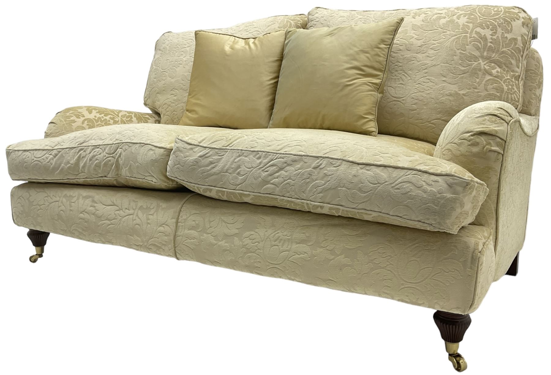 Multi-York - Howard shape two-seat sofa, upholstered in scrolling floral pattern loose covers, rolled arms, on turned front feet with brass cups and castors
