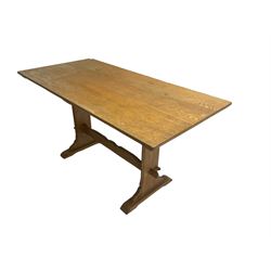 Mid-20th century rectangular oak dining table, shaped solid end supports joined by stretcher on sledge feet 