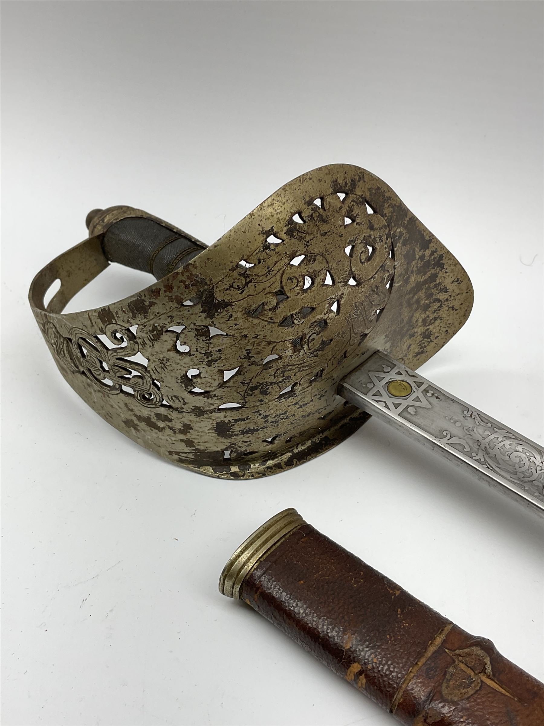 George V 1897 pattern army officer's sword the 82.5cm etched blade by Flights Ltd London, Winchester, Aldershot & Camberley, nickel plated pierced hilt and wire bound fish-skin grip, in leather scabbard, L101cm overall