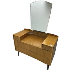  Mid-20th century light oak dressing table, raised shaped mirror back over two short and two long drawers, on splayed and tapering black finish supports 