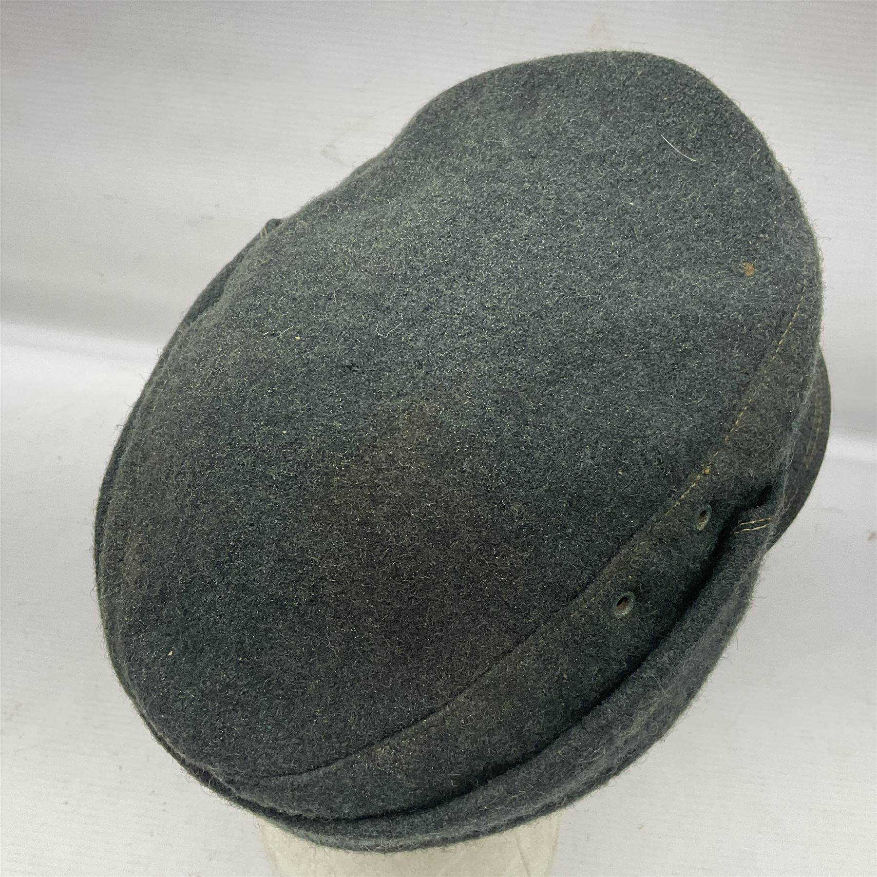 WWII German M43 field cap with 'SS' cloth badge and mountain trooper's edelweiss metal badge