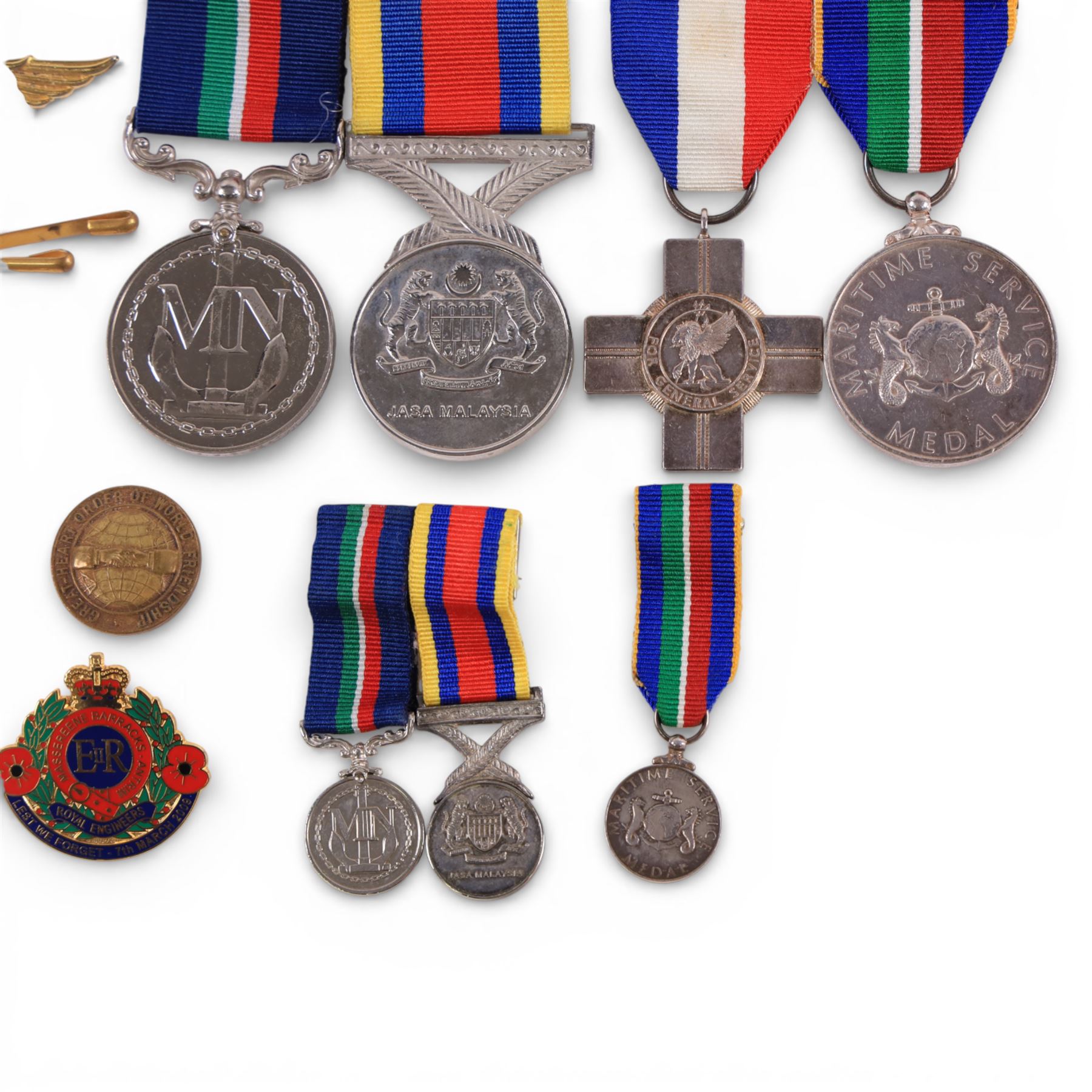 Two silver Merchant Navy service medals, both hallmarked, five other medals including miniatures and a collection of enamel pin badges