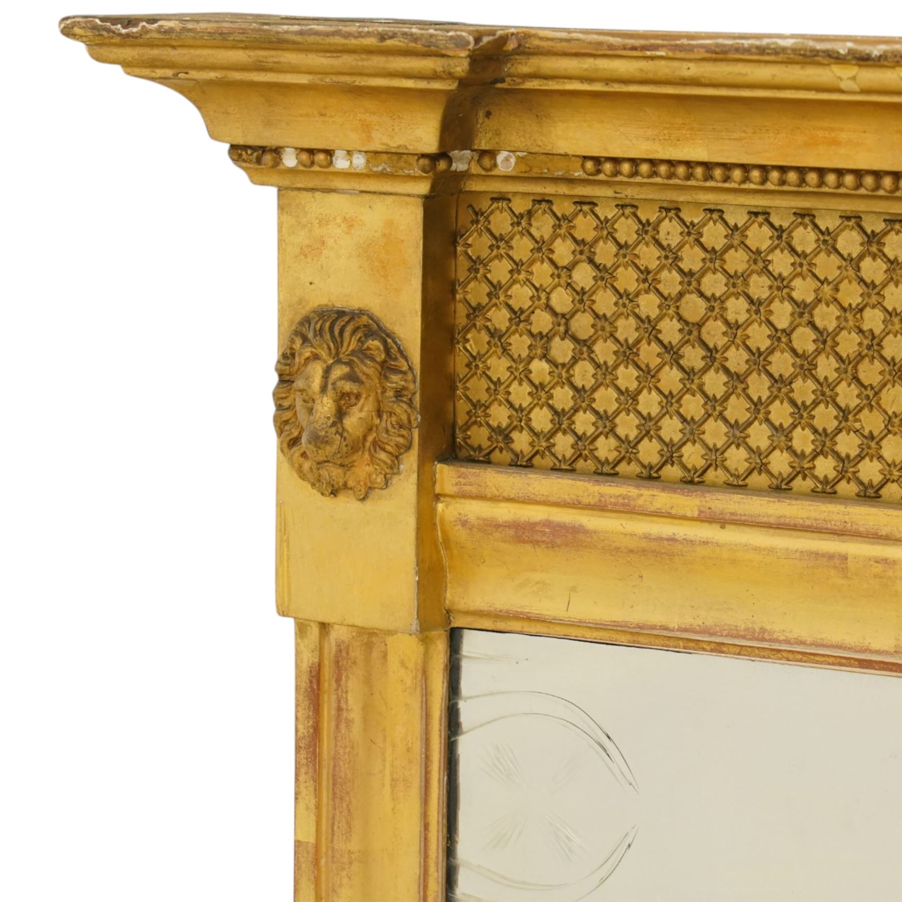 Regency style giltwood and composition tripartite overmantel mirror, rectangular frame with stepped cornice above a pierced geometric frieze, central mirror plate flanked by narrow etched floral side plates, with applied rosette paterae and moulded borders