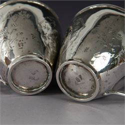 Pair of Chinese export silver teacups, both decorated with character marks, one with floral decoration, the other decorated with a bird within bamboo branches, both with indistinct maker's marks beneath, H6cm