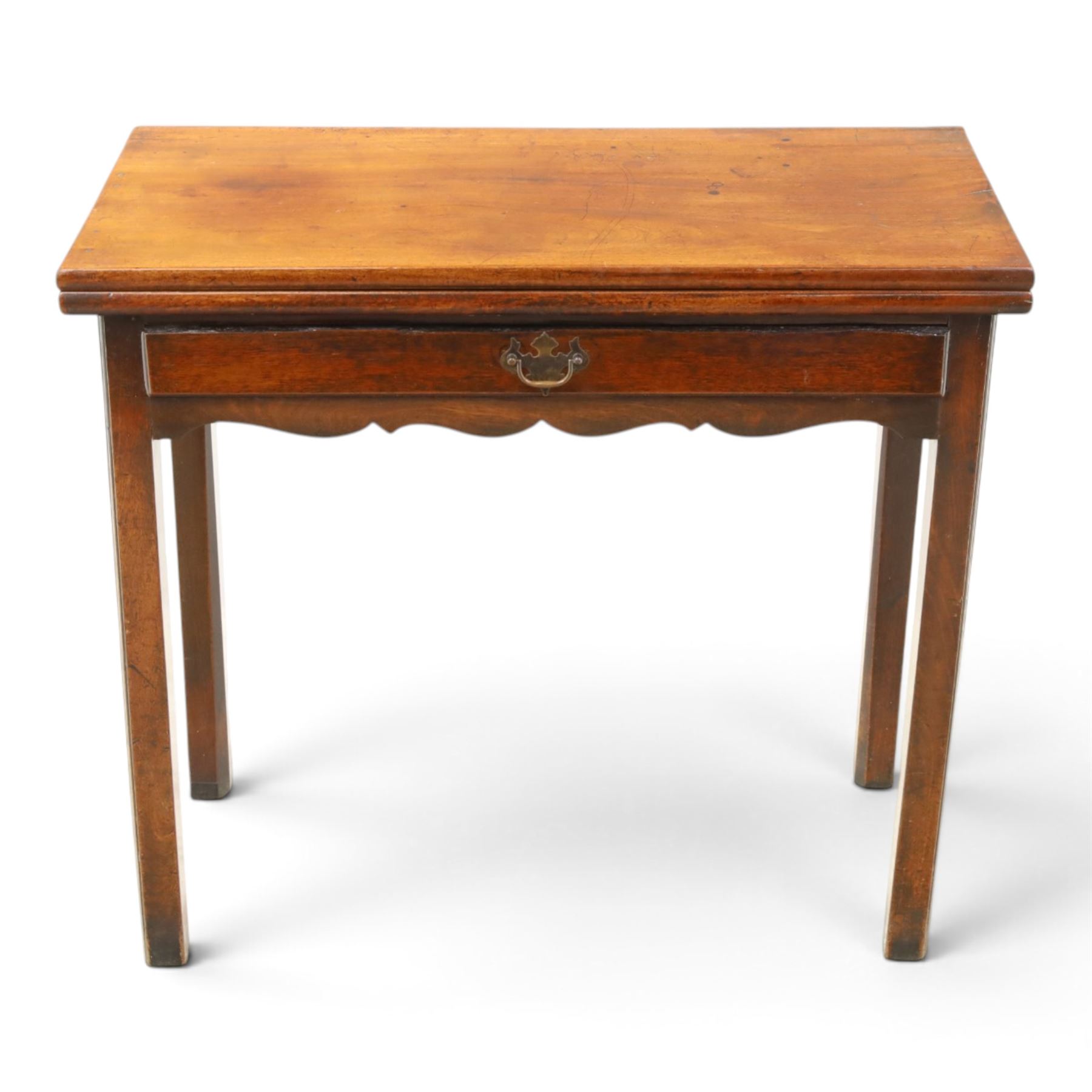 Georgian oak tea table, rectangular fold-over top above single frieze drawer with brass swing handle, shaped apron, gateleg raised on square tapering supports