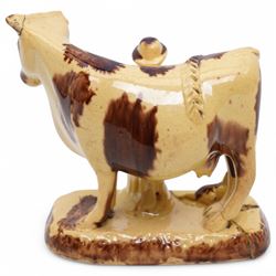 Early 19th century pottery model of a cow with drab colouring accompanied by a standing figure and a dog on naturalistic base, possibly South Yorkshire L14cm x H14cm