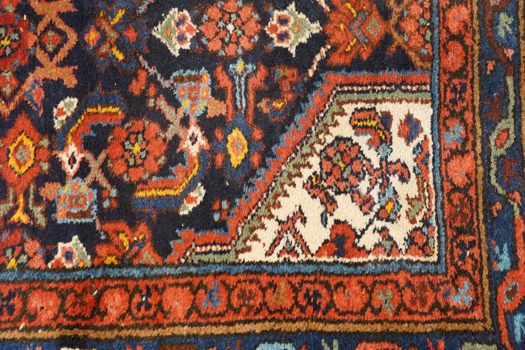 Large vintage Persian Hamadan indigo ground runner rug, the busy field with central ivory medallion and spandrels, surrounded with Herati motifs and stylised plant symbols, with multiple floral decorated guard bands