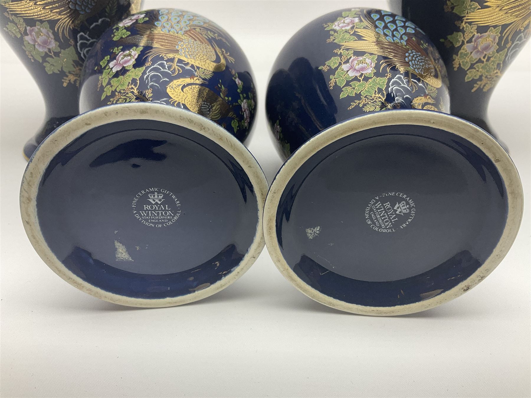 Two pairs of Royal Winton vases, decorated with peacocks on a blue ground, largest H24cm