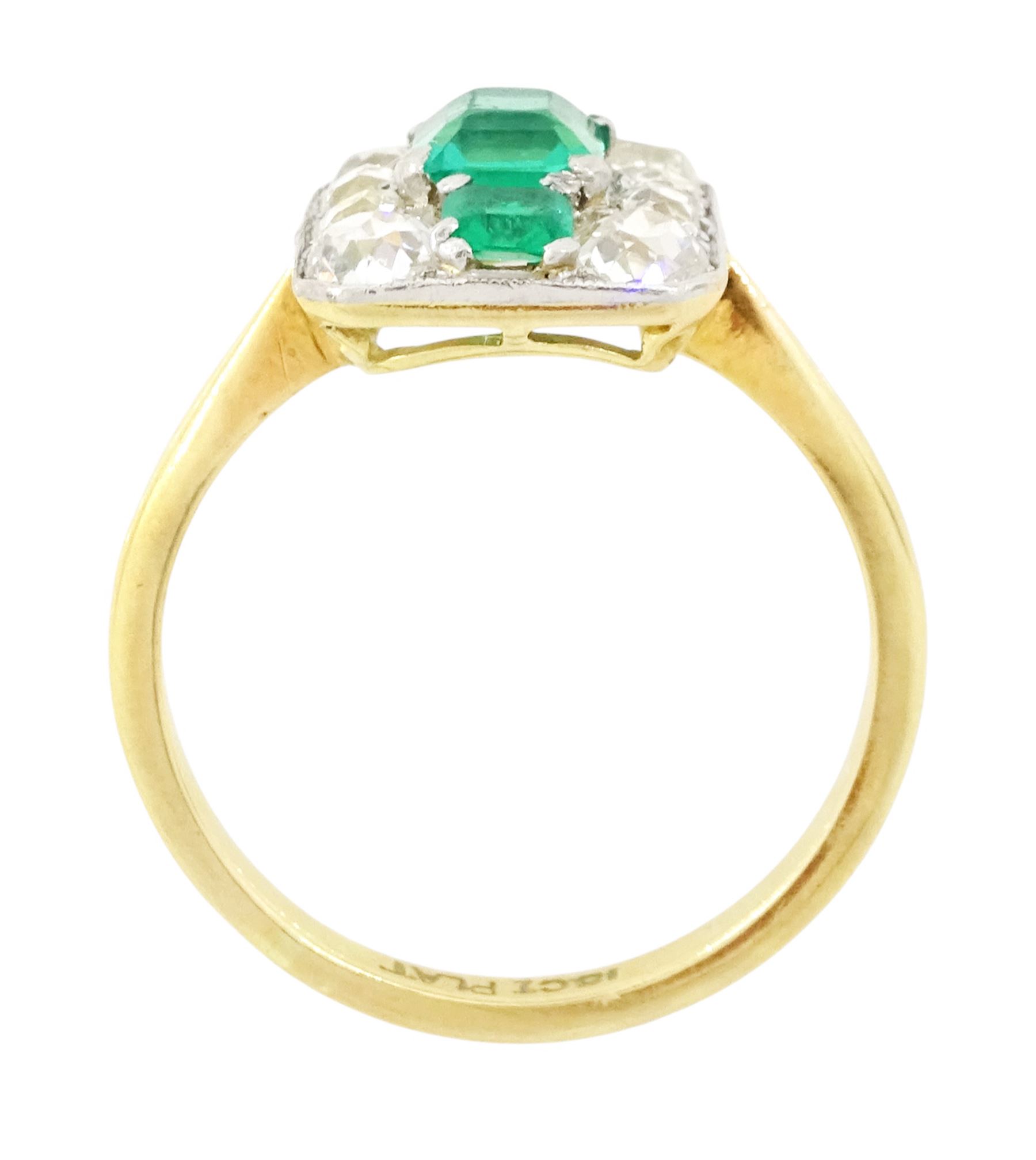 Early 20th century gold emerald and diamond panel ring, three octagonal cut emeralds, with four old cut diamonds set either side, stamped 18ct Plat, total diamond weight approx 0.85 carat