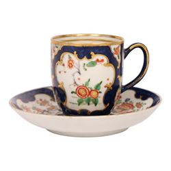 18th century Worcester coffee cup and saucer, circa 1770,  painted with shaped panels of chrysanthemums and banded hedges on a blue scale ground with gilt detail to the rim, mark beneath, H8cm 