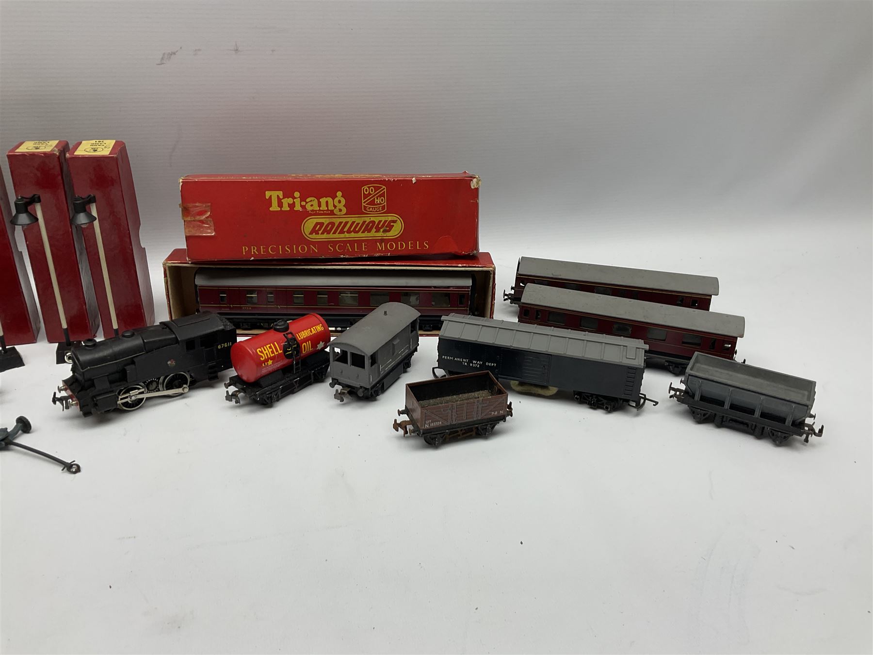 Trix Twin Railway - Hunt Class 4-4-0 locomotive and tender 'Pytchley' No.62750, boxed; 0-4-0 tank locomotive with plastic body No.67611; three passenger coaches (one boxed); six goods wagons; three boxed Yard Lamps etc; and Tri-ang Track Cleaning Car, boxed