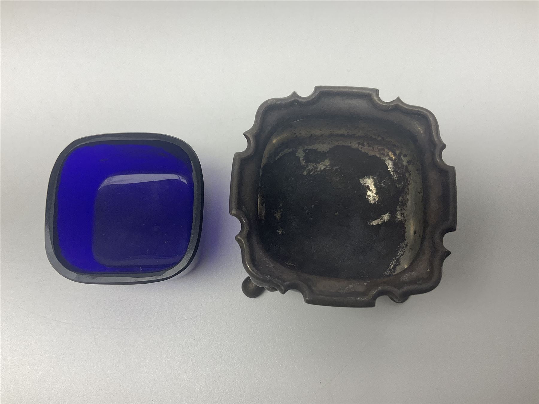 Modern two piece silver cruet set, comprising pepper shaker and open salt, each with shaped rims and upon four pad feet, hallmarked William Suckling Ltd, Birmingham 1962, together with an early 20th century silver open salt, of oval form, hallmarked William Aitken, Birmingham 1918