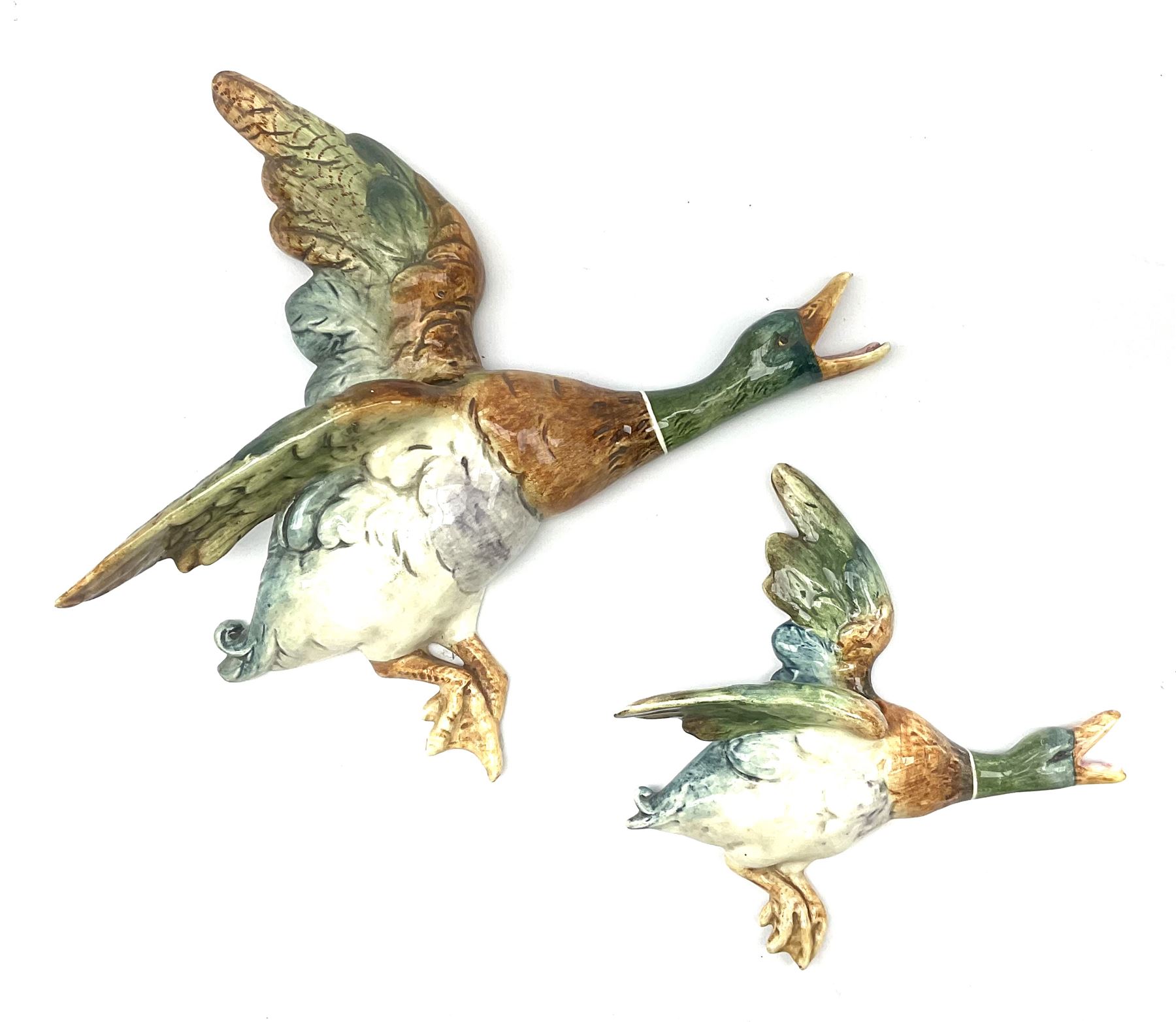 Two Royal Dux wall mounted ducks in flight, both with printed marks verso detailed Made In Czechoslovakia, and impressed marks, largest example L32.5cm, smallest example L21.5cm. 