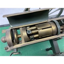 Scratch built brass model of an 1861 Gatling Gun with rotating barrels, hinged cover revealing mechanism, on metal bound wooden spoked wheels and rectangular base L47cm H22cm