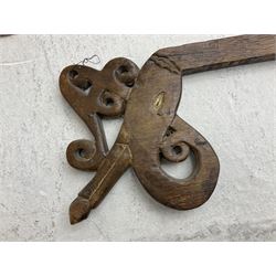 Ikat Man’s Cloth (Hinggi Kombu), East Sumba, Indonesia, woven in red, blue and yellow-brown warp ikat, constructed of two mirroring long panels, the motifs arranged in four bands depicting warrior figures astride rearing horses, high-ranking figures and guardians within geometric borders, on carved wooden wall hanger, L295cm
