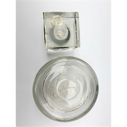 A Victorian thick glass inkwell, of compressed globular form, D14.5cm, together with am early 20th century silver mounted glass inkwell, of square form, the hinged cover hallmarked Grey & Co, Chester 1912, H6.5cm.