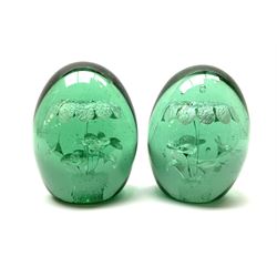 A pair of Victorian green glass dump paperweights, with internal foil flower decoration, H12.5cm. 