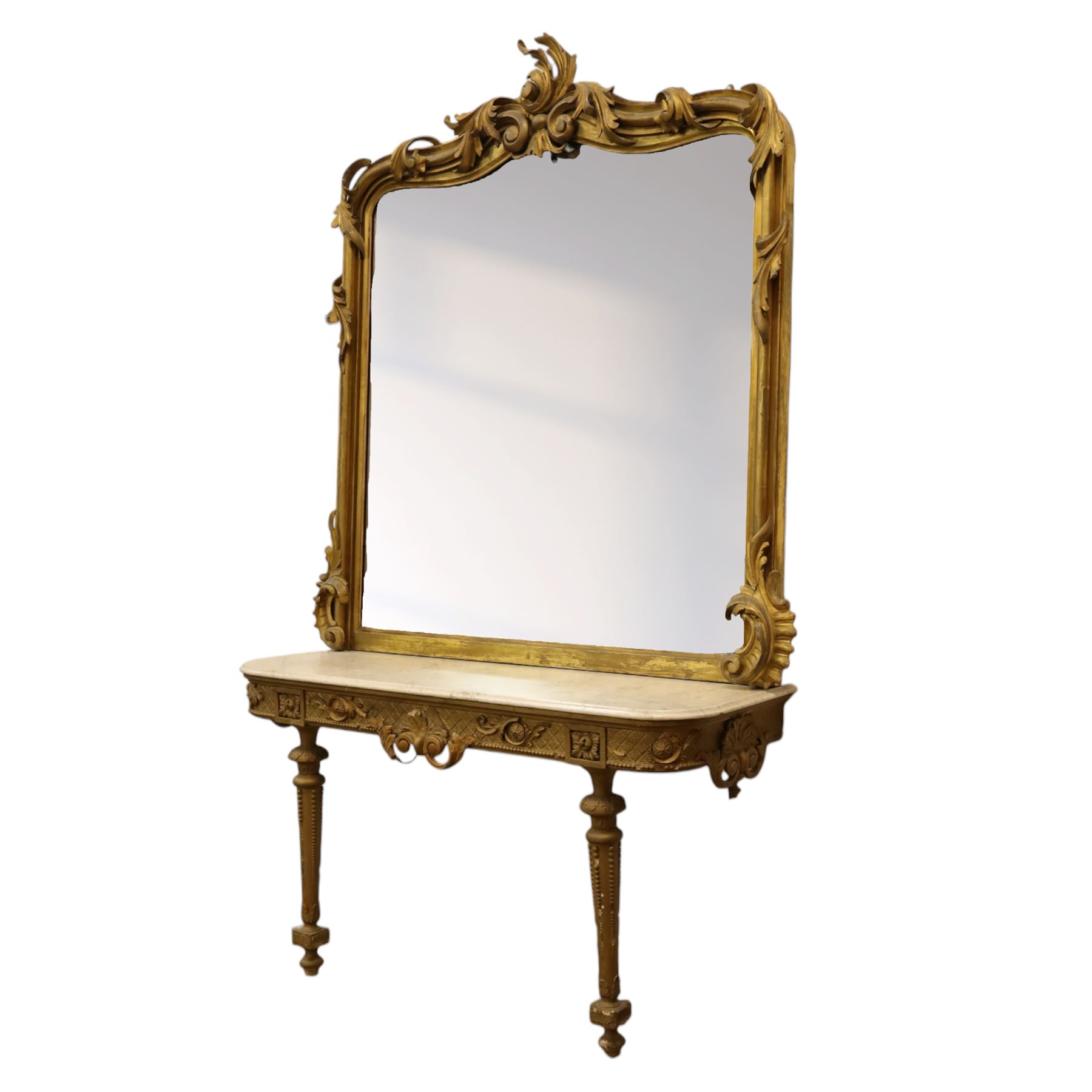 Large late 19th century Rococo revival giltwood and gesso pier mirror, the rounded rectangular frame with richly carved crest and scrolls with acanthus leaves and foliate ornamentation, above a giltwood console table with Carrara marble top and richly carved guilloche and ribbon tied laurel garland frieze, rosettes, and central scrollwork, raised upon tapered legs with beaded moulding and square block above with turned toupie style terminal  