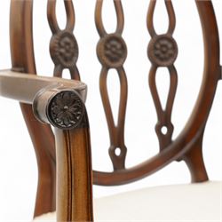 Set of six (4+2) late 19th to early 20th century Hepplewhite design mahogany dining chairs, moulded oval framed back with three shaped and pierced upright rails decorated with floral carved roundels, upholstered in pale fabric, on square tapering supports with recessed panels and block feet 