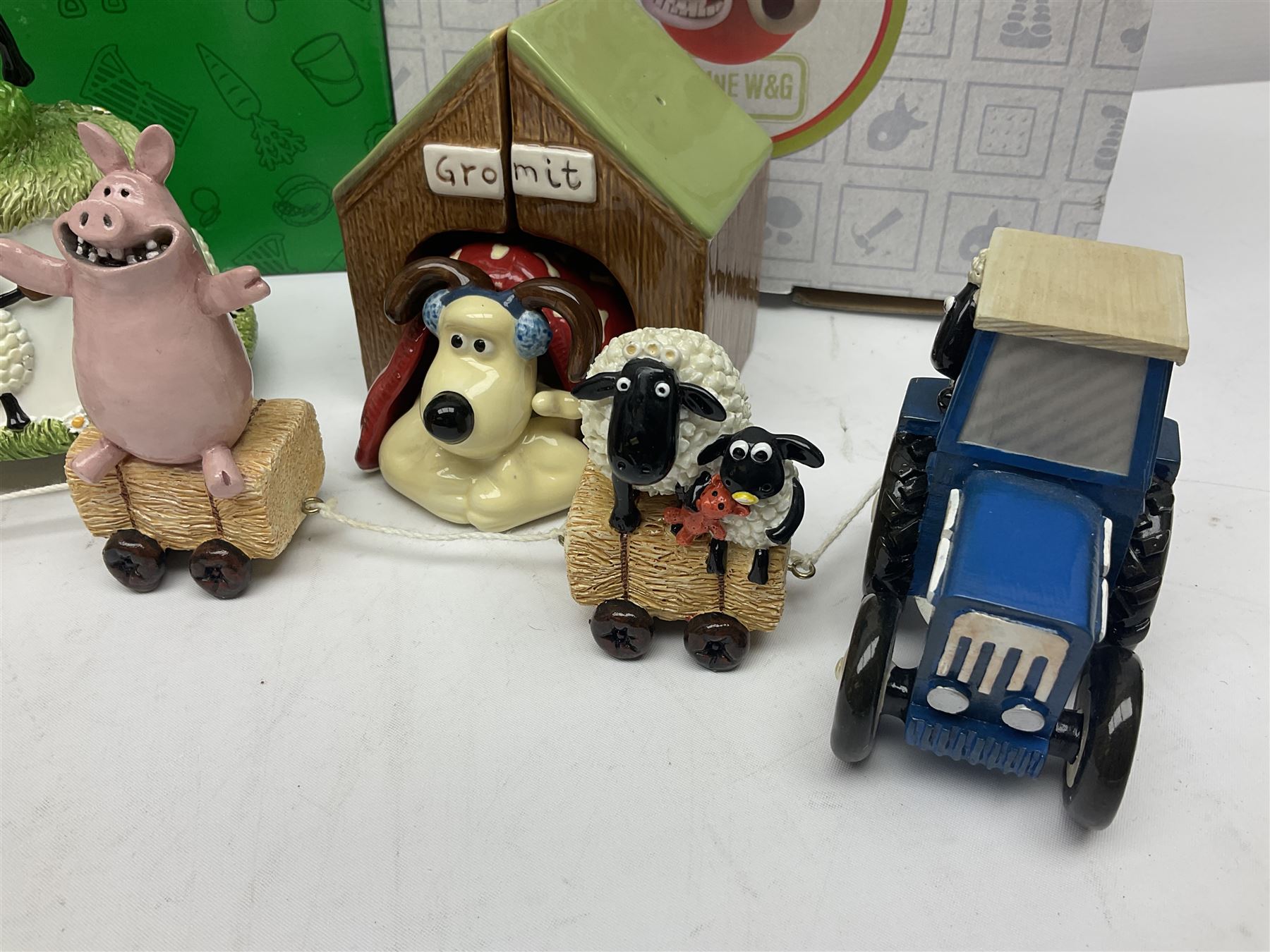Border Fine Arts Shaun The Sheep Tractor Train and musical figure, together with a Wallace and Gromit photograph frame and a Gromit cruet sett, three in original boxes  