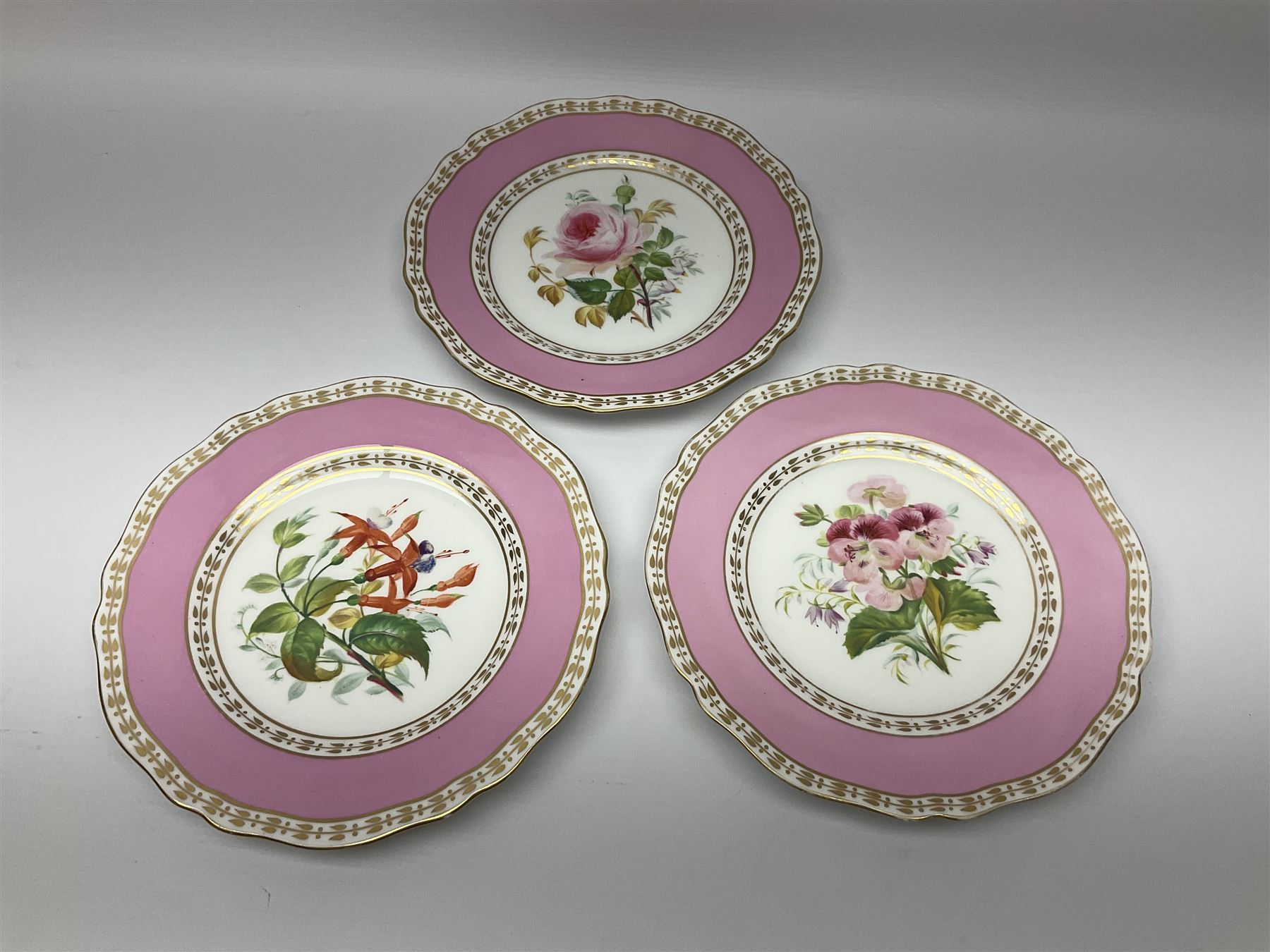 Victorian Copeland, Botanical dessert service, decorated with floral sprigs to the centre with a pink and gilt border, comprising five comports and seven plates, largest comport H20cm, plate D22cm
