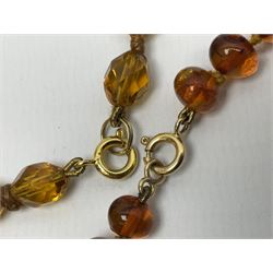 Amber bead necklace with gold clasp, stamped 9K, silver and silver jewellery including bobbin wheel, needle case, three spoons, locket pendant, rings and bracelets, all hallmarked or tested, collection of costume jewellery and Limit wristwatch 