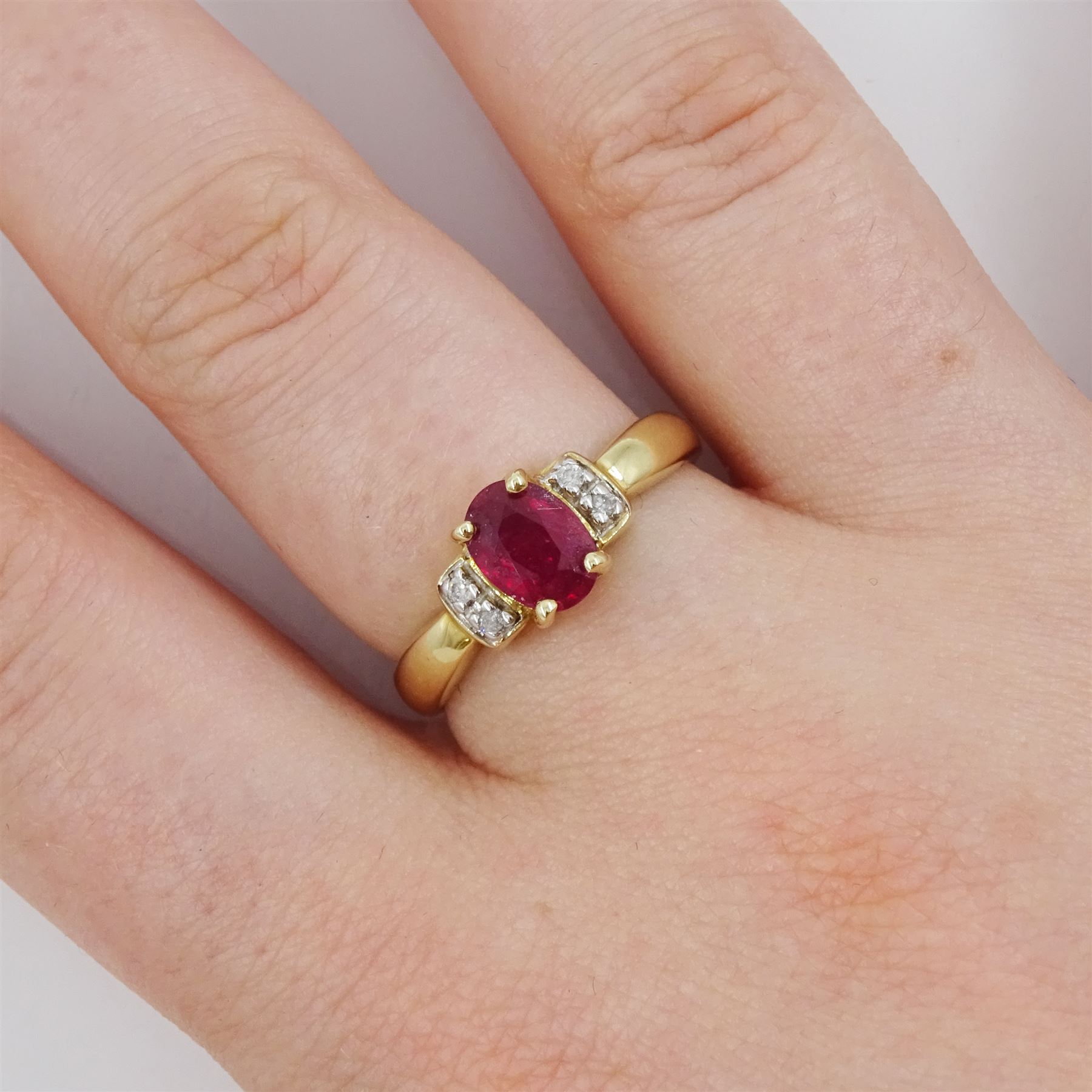 9ct gold single oval cut ruby and four stone, round brilliant cut diamond ring, hallmarked, ruby approx 0.75 carat