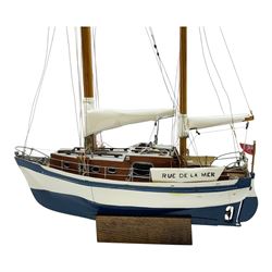 Scratch built model yacht 'Rue de la mer', with painted blue and white hull, with acrylic case, model H67.5cm