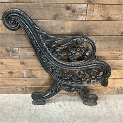 Early 20th century heavy cast iron three piece bench ends, decorated with scrolls and floral swags