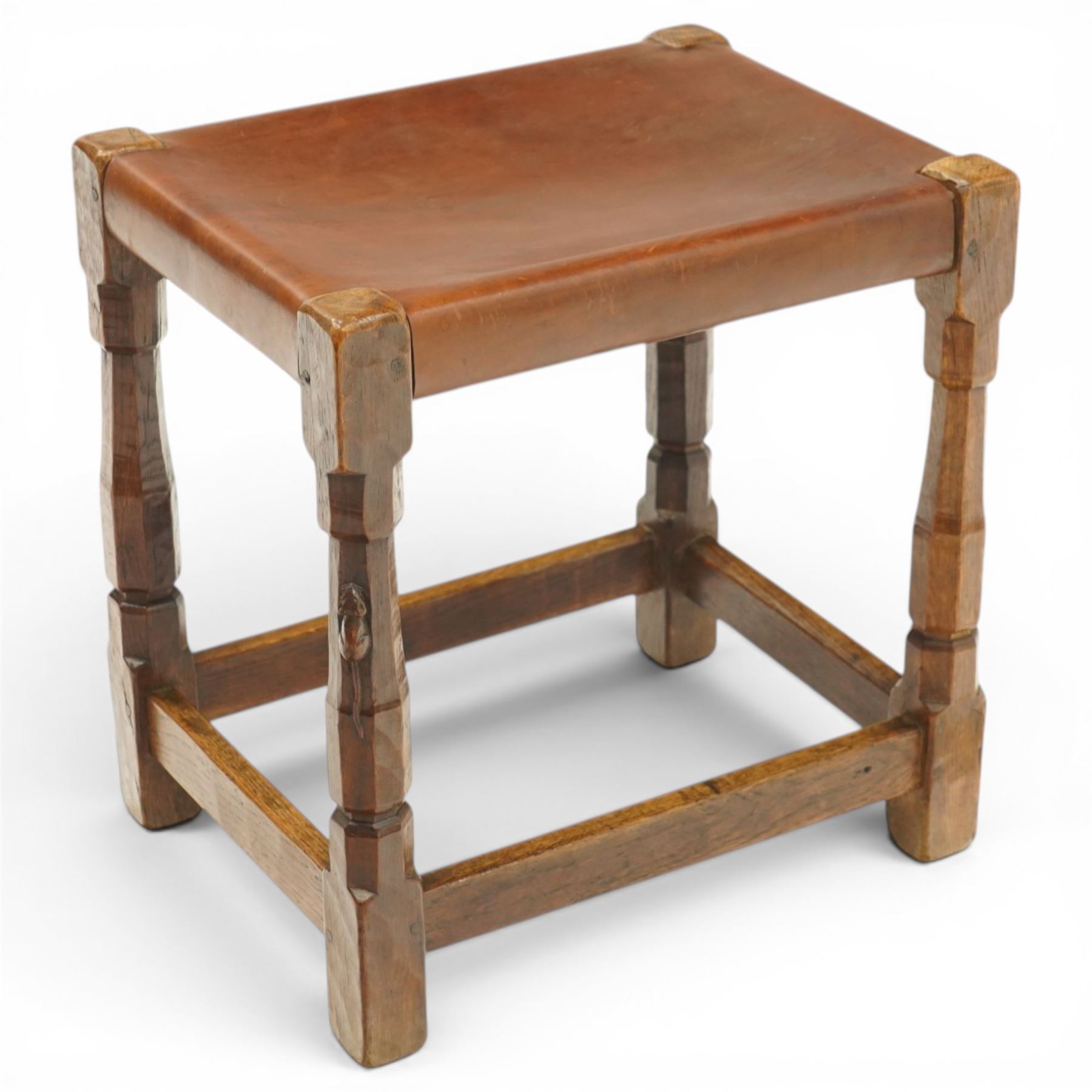Mouseman - 1940s dark oak dressing table stool, the rectangular top with deep-tan leather seat, raised on octagonal supports united by box stretcher, with carved mouse signature, by the workshop of Robert Thompson of Kilburn