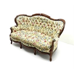 Victorian mahogany framed two seat, shaped back, scrolling arms, cabriole feet, upholstered in a deep buttoned ivory fabric with floral pattern