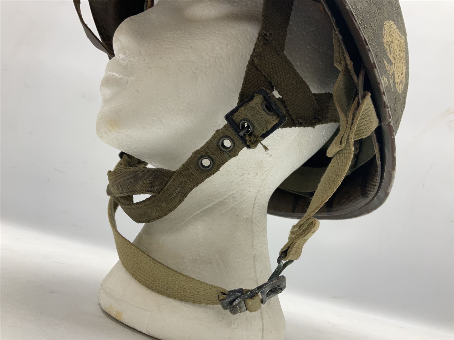 American first type paratrooper helmet with post-WW2 strap and D-rings and later 1944 liner bearing Firestone Tyre and Rubber Company mark; green textured finish