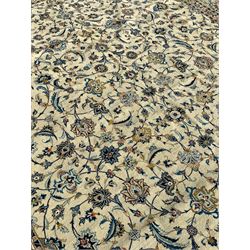 Persian Kashan carpet, light sage green ground, the field decorated all-over with interlaced foliate and plant motifs, repeating scrolled border with stylised flower head motifs
