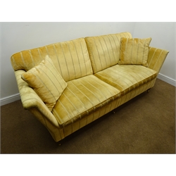  Duresta Ruskin style Grande sofa upholstered in pale gold fabric, turned supports on castors, W225cm  