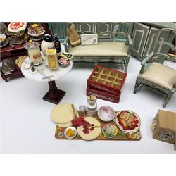 Collection of miniature dolls house furniture, to include display cabinet with pink and white floral dinner service, two serving trolleys with cakes and sweets and two blue painted kitchen dressers, together with miniature dolls house cardboard food packaging and animal figures including dogs and cats, etc