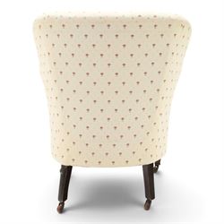 Edwardian inlaid mahogany armchair of modest proportions, spoonback and loose seat cushion on sprung seat upholstered in ivory ground floral fabric, on square tapering supports with ceramic castors
