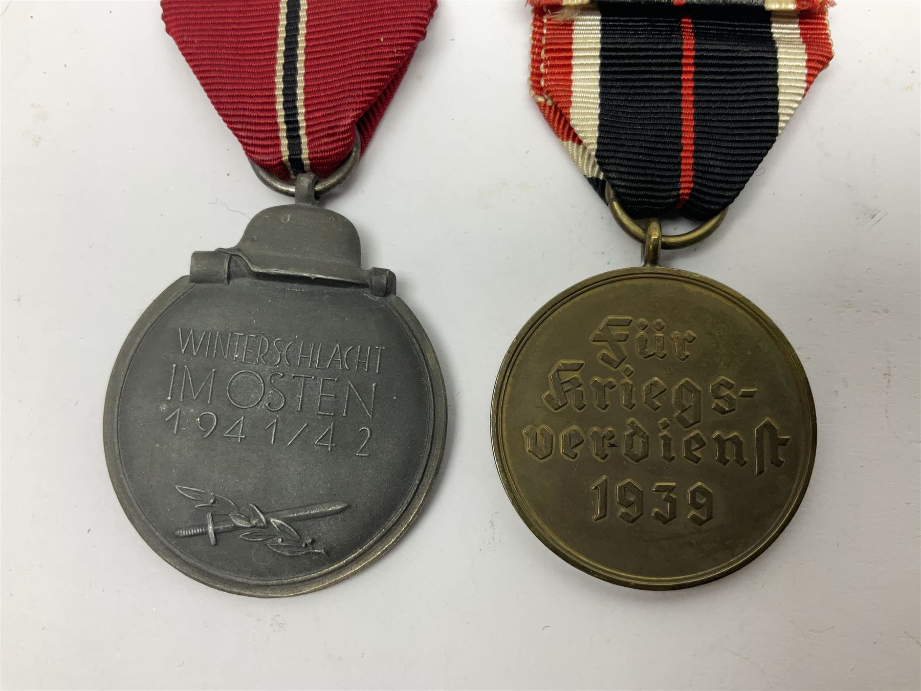 German War Merit Cross 1st Class, the pin-back stamped '50'; War Merit Medal; and Ostfront Medal for the Winter Campaign in Russia of 1941-1942 'Die Medaille Winterschlacht Im Osten'; all with ribbons (3)