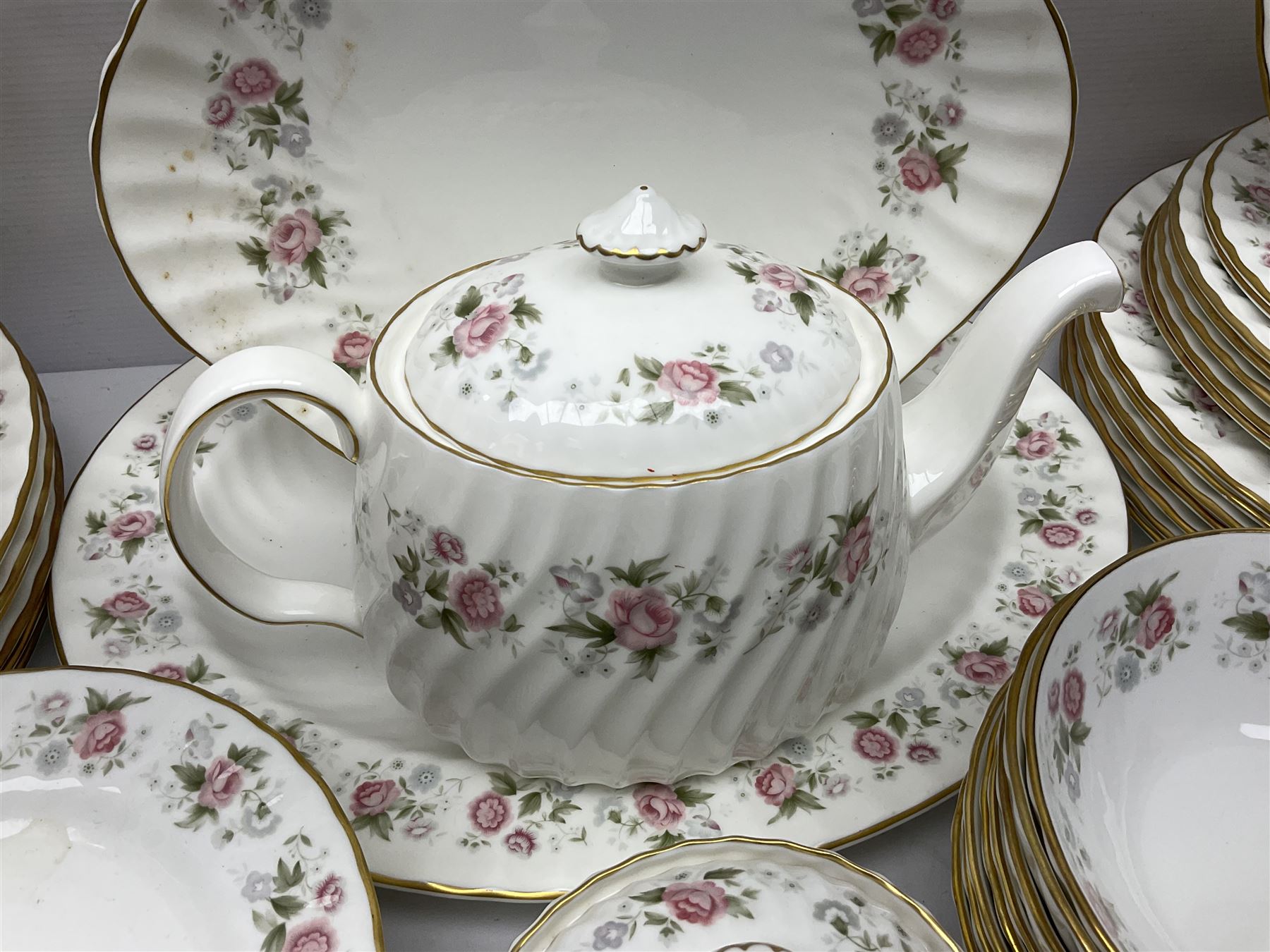 Minton Spring Bouquet pattern dinner and tea service, comprising dinner plates, twin handled tureens with covers, meat platter, teapot, milk jug, sugar bowl with cover, tea cups and saucers, bowls, cake plate, side plates, dessert plates, etc all with printed mark beneath (82)