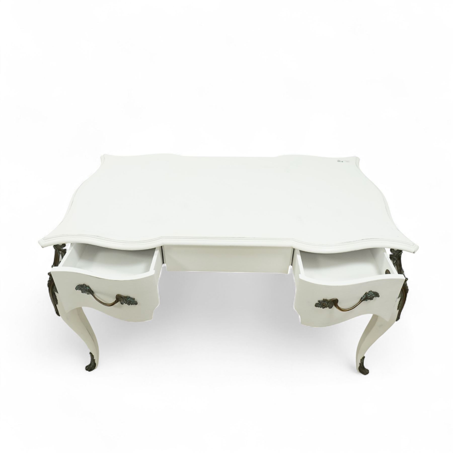 And So To Bed - French design white painted dressing table, serpentine top over two drawers, with decorative mounts and shaped cabriole legs