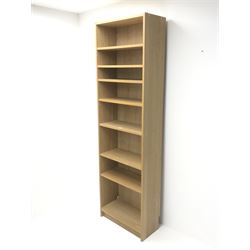 Light oak open bookcase, seven shelves, plinth base