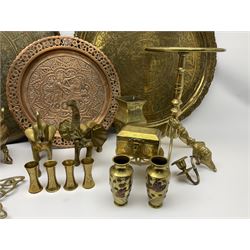 Two Eastern brass chargers, chased with Deities and figures, and foliate and diaper type borders, each approximately D57cm, together with an Eastern copper plate with pierced rim, embossed with a figure and zoomorphic creature, D38cm, and other brassware including small pair of Japanese Meiji period vases, Eastern flask, koro with foo dog finial to the cover, two large trivets, one example with folding top, etc. 