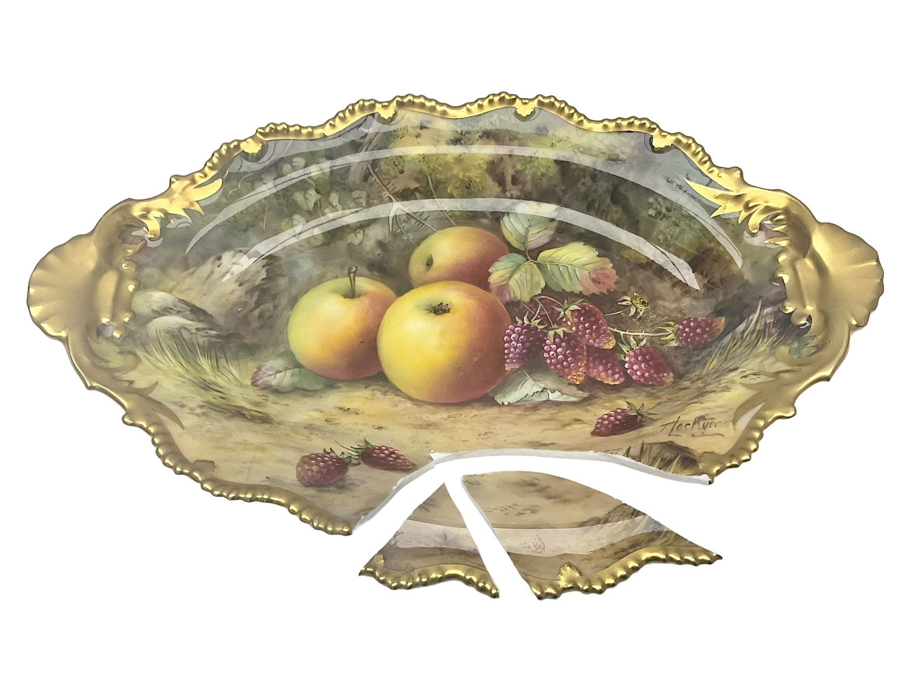 Early 20th century Royal Worcester dish decorated by Thomas Lockyer, oval form with gilt shaped rim and twin shell handles, hand painted with a still life of fruit upon a mossy ground, signed T Lockyer, with puce printed mark beneath and date code for 1922, for restoration, W31cm