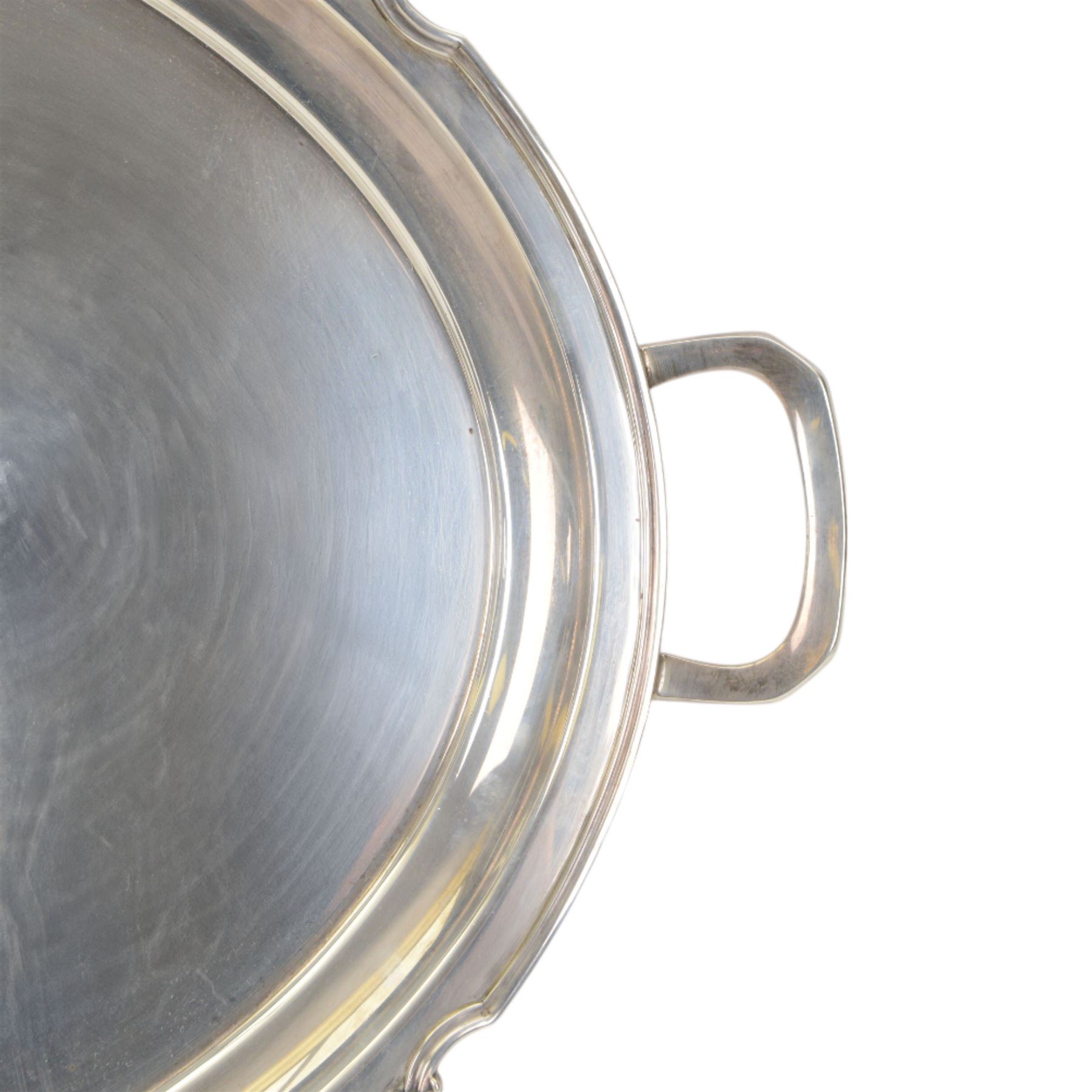 Modern silver twin handled serving tray, of oval form with stylised bud and tendril detail to rim, hallmarked Garrard & Co Ltd, Sheffield 1970, also impressed Garrard & Co Ltd 112 Regent Street beneath, including handles L64cm
