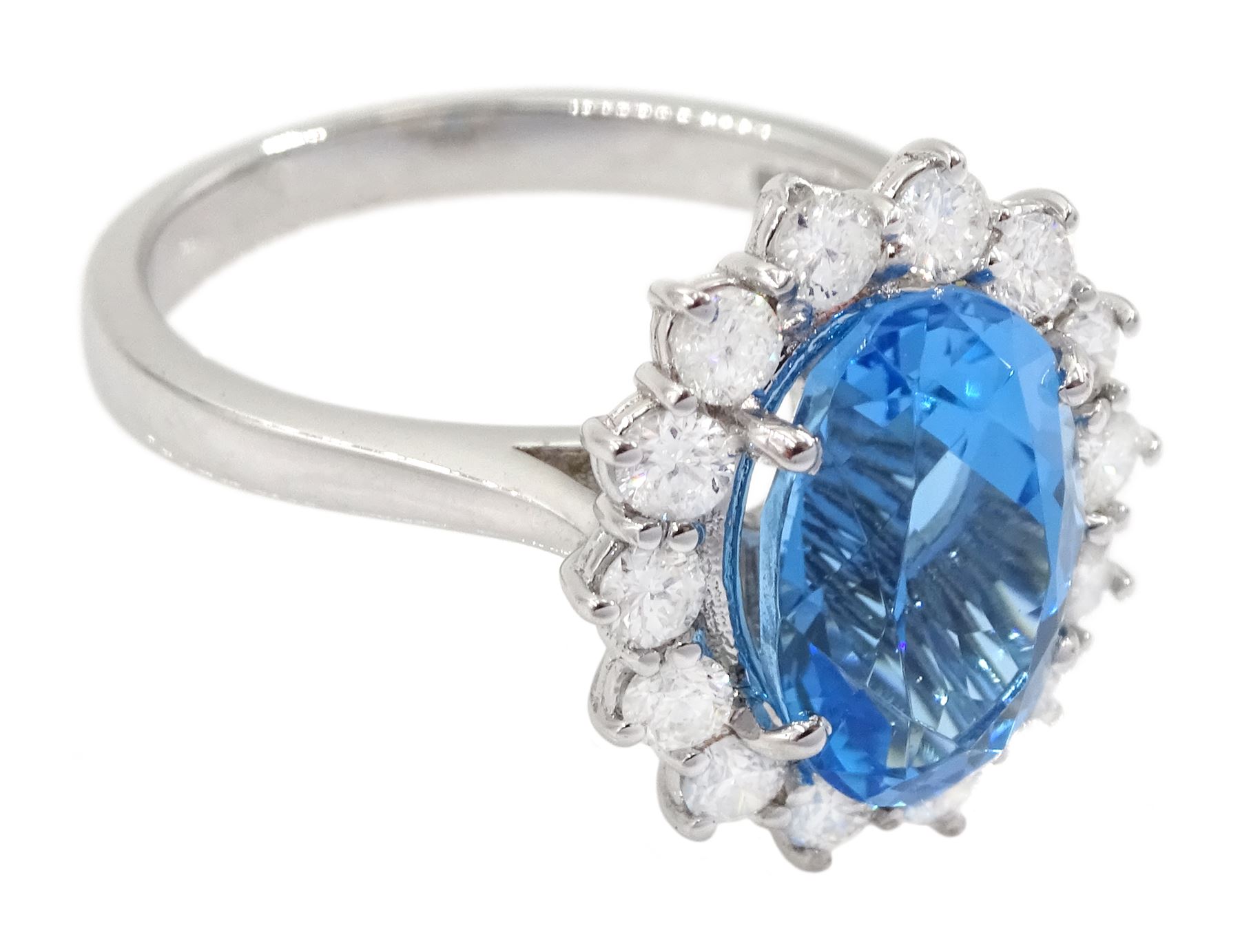 18ct white gold oval cut Swiss blue topaz and round brilliant cut diamond cluster ring, hallmarked