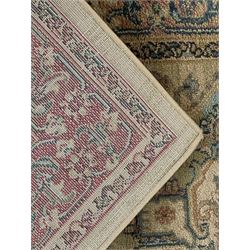 Ziegler-style machine-made rug, beige ground with a multicoloured central medallion and floral motifs, spandrels with scrolling designs, framed by a decorative border with intricate patterns