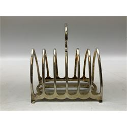 Silverplate Gothic style toast rack, with seven arched bars, openwork handle and bracket feet, H17.5cm